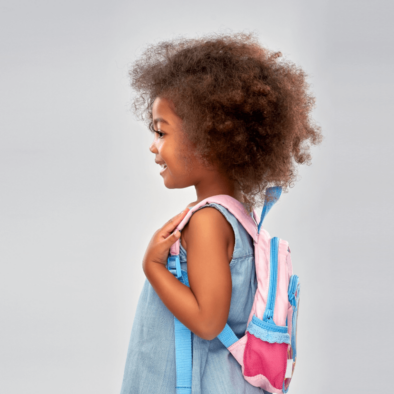 Little girl wearing a backpack