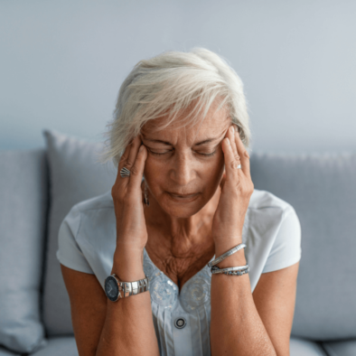 Older woman holding her head in pain